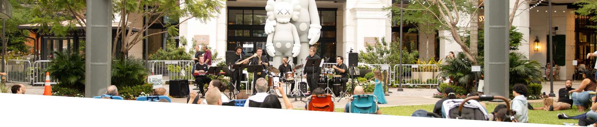 Band playing in front of Kaws Modern Art lawn event