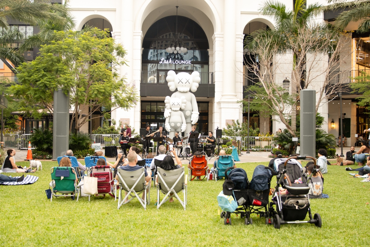 People watching band from lawn